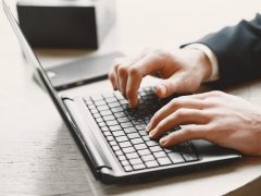 Contractor managing insurance repair jobs on software dashboard