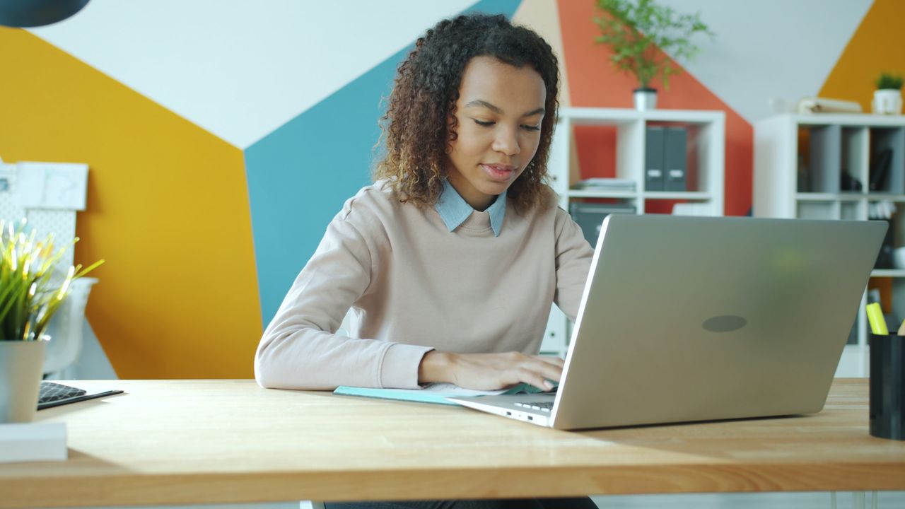 Employee organising business files on a computer